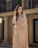 Woman wearing a Golden Beige Korean Raw Silk suit, glancing to the side with hand in hair