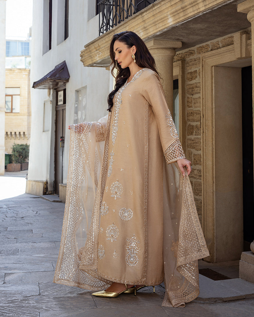 Side profile of a Golden Beige Korean Raw Silk suit, organza dupatta draped over the arm