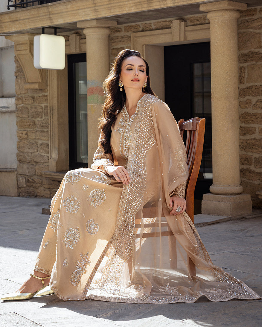 Styled seated portrait in a Golden Beige Korean Raw Silk suit with the dupatta flowing to the floor