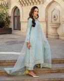 Side view of icy blue raw silk suit with embroidered organza dupatta trailing down steps