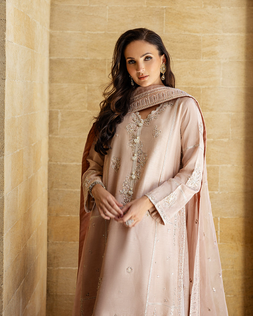 Close-up of pearl-embellished neckline on rose beige Korean raw silk shirt