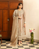 Woman wearing dark beige embellished lama silk suit, front standing by wooden cabinet