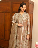 Woman wearing dark beige lama silk suit, close-up front, looking down