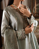 Woman wearing sea green silver zarri silk suit, close-up of embellished bodice with hand at chest