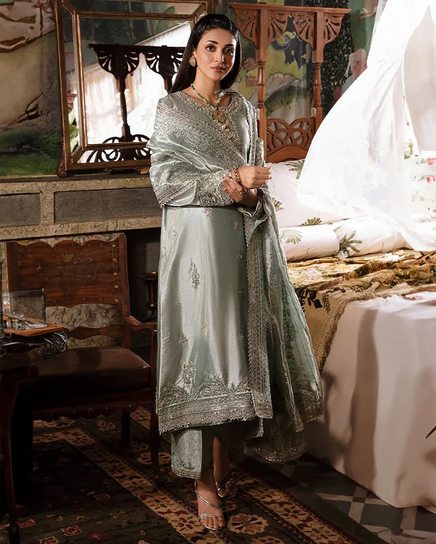 Woman wearing sea green silver embellished zarri silk suit, front standing in bedroom setting