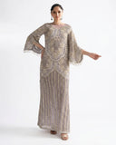 Woman wearing a Lilac Net suit embellished with pearls, crystals, and dabka embroidery