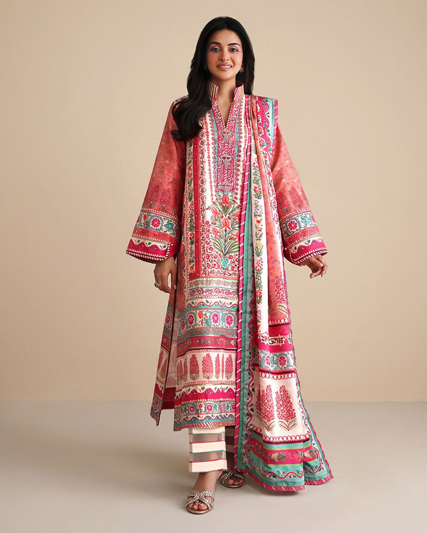 Woman wearing peach printed raw silk suit with striped dupatta border and embroidered neckline