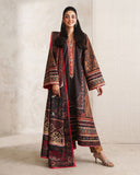 Woman wearing black printed raw silk suit with red trim and striped trouser