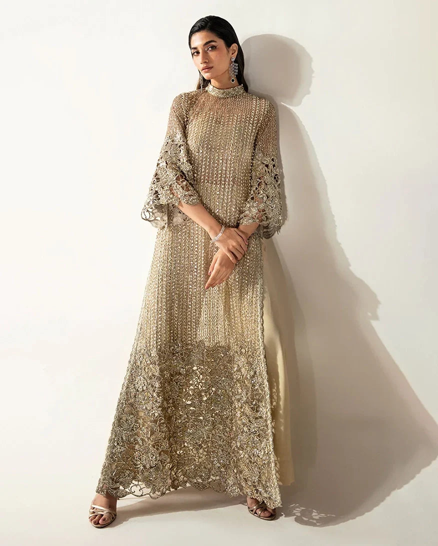 Woman wearing a Pale Gold Net suit embellished with crystals, pearls, and Swarovski elements