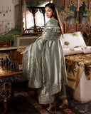 Woman wearing sea green silver zarri silk suit, back view, side profile near chess table
