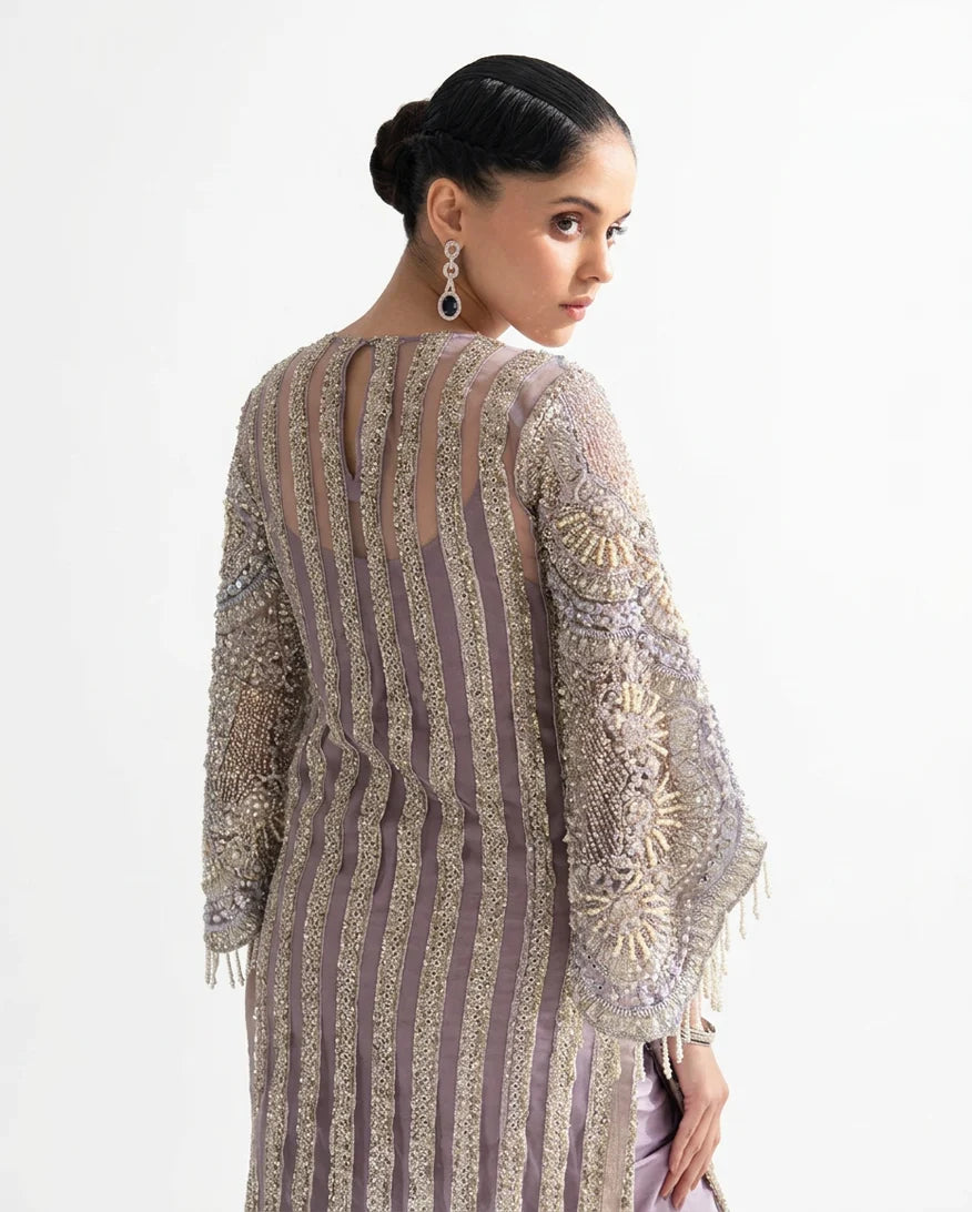 Back view of a Lilac Net suit showing dabka-embroidered panel detailing