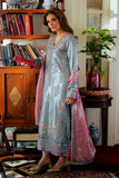 Woman wearing blue satin zari suit, side standing, holding a book