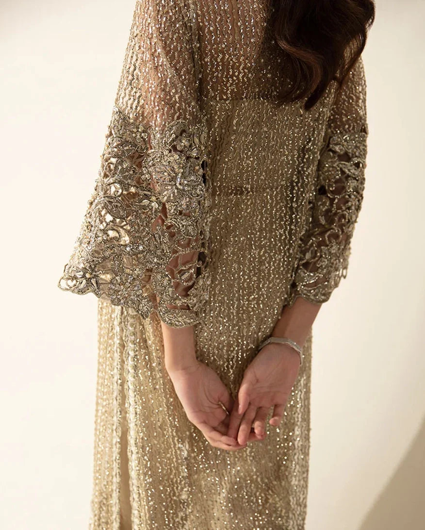 Close-up of crystal and pearl embellished sleeve cuff on a Pale Gold Net suit
