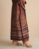 Close-up of side slit and embroidered hem border on black printed raw silk suit