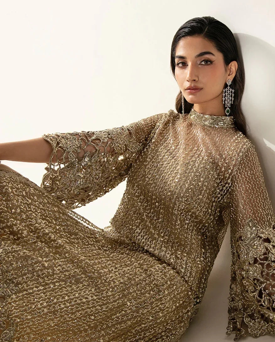 Reclining portrait in a Pale Gold Net suit showing crystal and Swarovski embellished sleeve detail