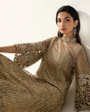 Reclining portrait in a Pale Gold Net suit showing crystal and Swarovski embellished sleeve detail