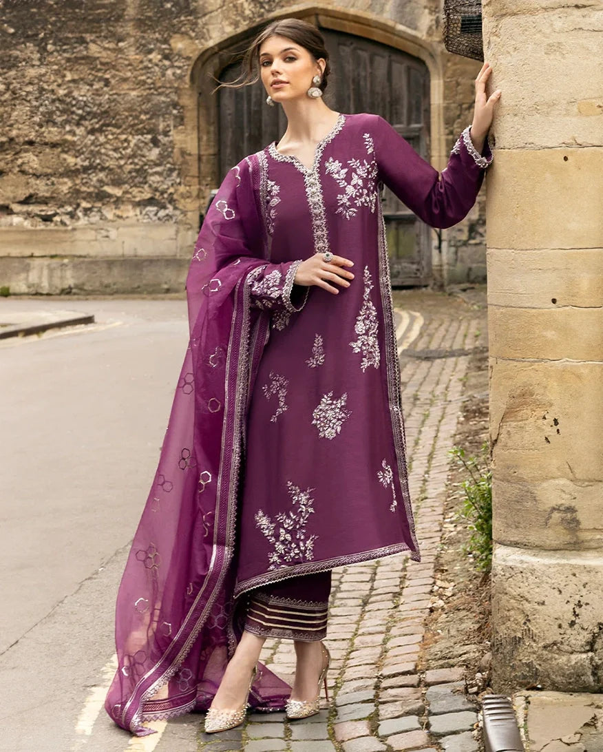 Woman wearing a Purple embroidered Raw Silk suit, hair caught in the breeze