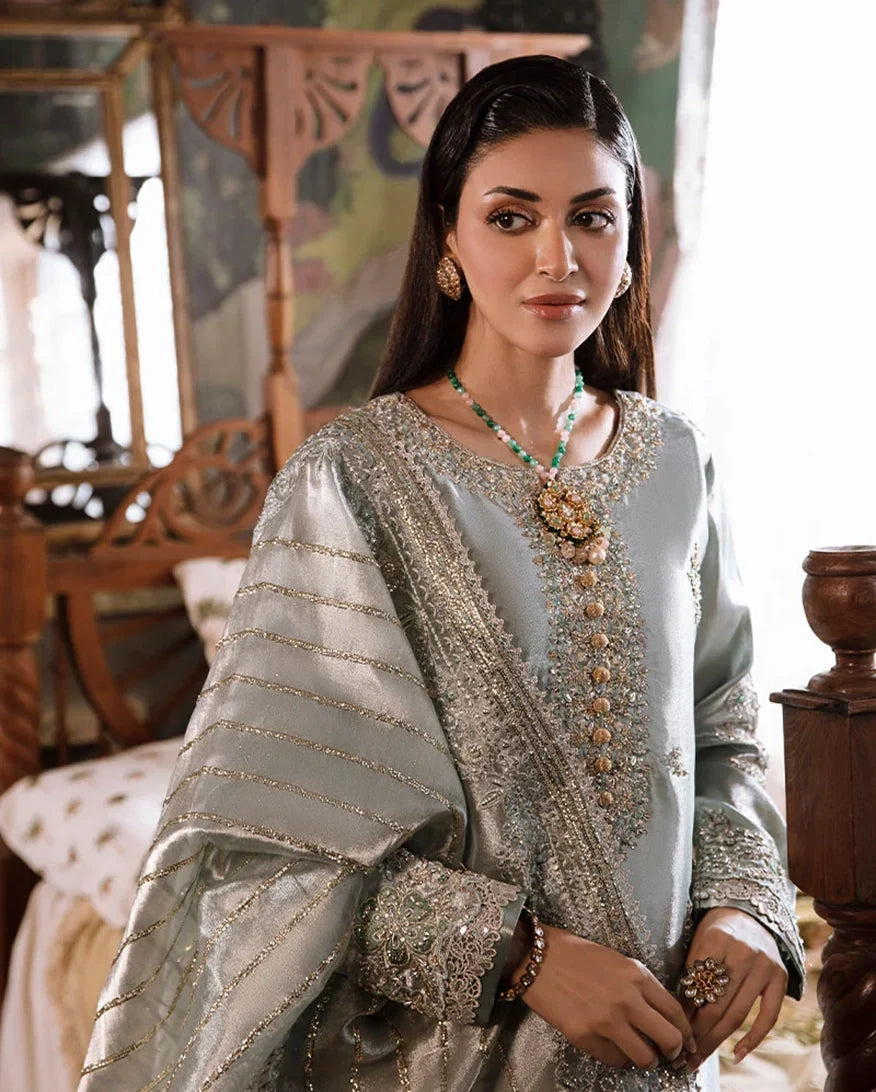 Woman wearing sea green silver zarri silk suit, close-up front portrait showing embellished neckline