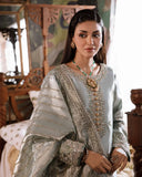 Woman wearing sea green silver zarri silk suit, close-up front portrait showing embellished neckline