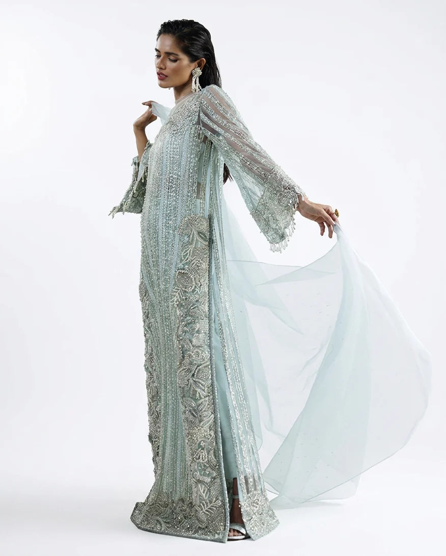Woman wearing an Aqua Net suit, the organza dupatta caught mid-flow