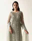 Close up of Woman wearing mint green embroidered net suit with pearl, crystal, and dabka embroidered cape sleeves