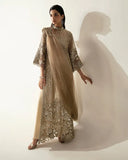 Woman wearing a Pale Gold Net suit with a sheer dupatta draped across the body