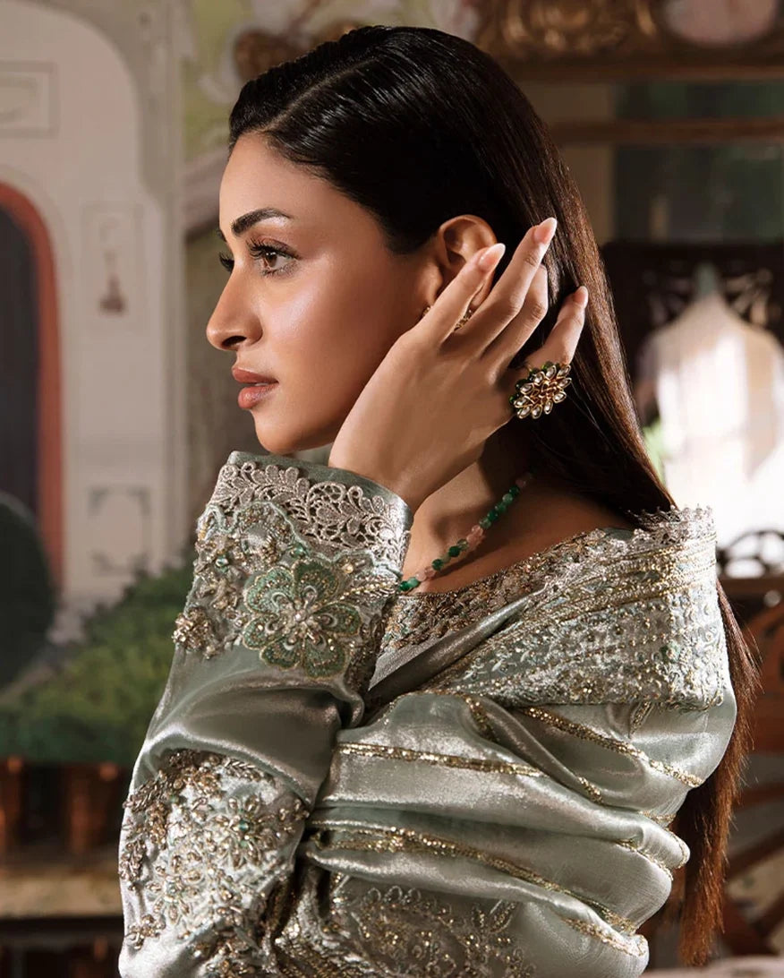 Woman wearing sea green silver zarri silk suit, close-up side profile portrait