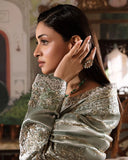 Woman wearing sea green silver zarri silk suit, close-up side profile portrait