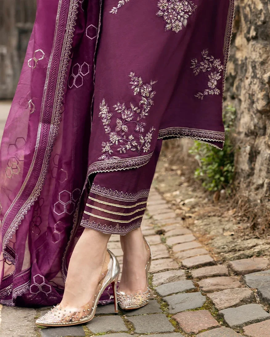 Close-up of the embroidered organza-bordered hem on a Purple Raw Silk suit