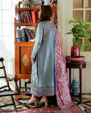 Woman wearing blue satin zari suit, back view, standing at bookshelf