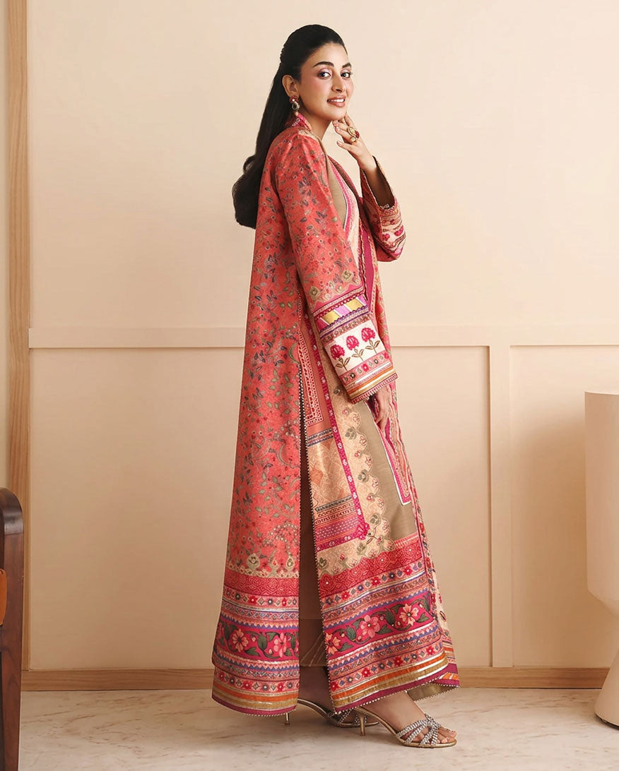 Side view of peach printed raw silk suit with hand at chin, showing sleeve embroidery