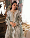 Woman wearing sea green silver embellished zarri silk suit, front standing, hands clasped