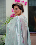 Woman wearing silver satin zari suit, close-up side portrait showing embellished shoulder