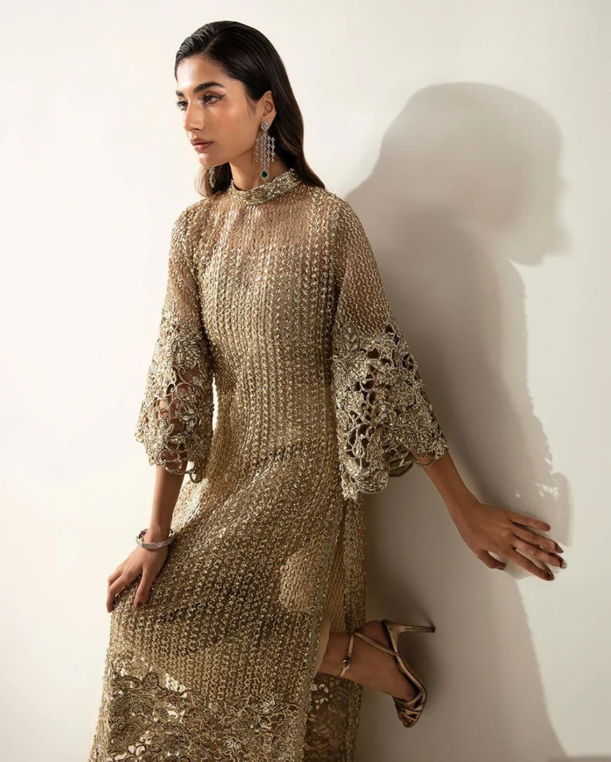 Woman wearing a Pale Gold Net suit, highlighting the sheer sleeve's crystal and pearl detailing