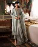 Woman wearing sea green silver embellished zarri silk suit, front standing, looking down