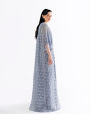 Side view of blue net suit showing fringed cape jacket draping and lattice embroidery