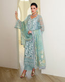Woman wearing Aqua Green Organza pret suit, draped sheer dupatta with gold embellishments, Espoir by Mushq