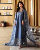 Woman wearing a blue luxury pret suit with silver embroidery, Zarminay collection