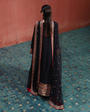 Back view of black raw silk suit with embroidered dupatta draped over both shoulders