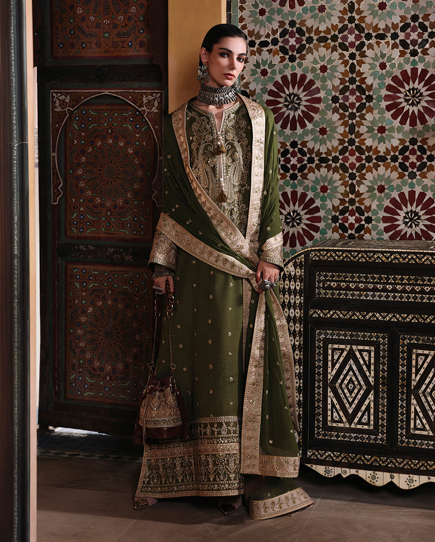 Woman wearing olive raw silk dress with dupatta wrapped diagonally across the body