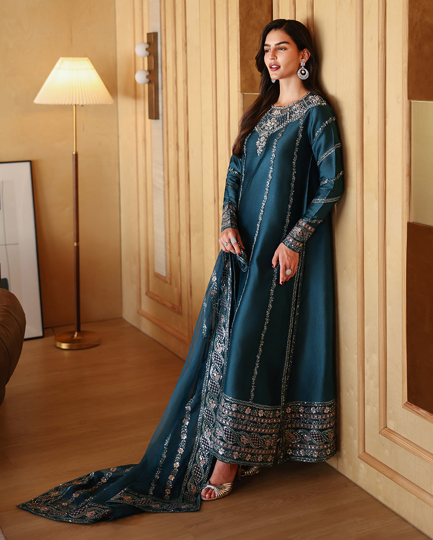 Side view of teal blue luxury pret suit with embroidered hem, Zarminay collection