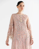 Close up of Woman wearing peach net kaftan with sheer dupatta draped and flowing behind