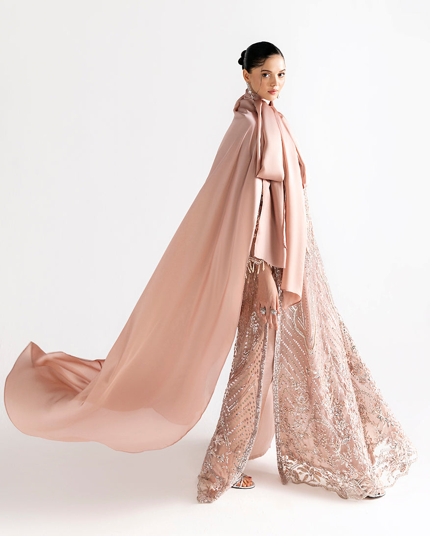 Side view of peach net kaftan showing front slit and embroidered vertical panels