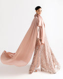 Side view of peach net kaftan showing front slit and embroidered vertical panels