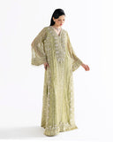 Woman wearing lime green embroidered net kaftan with fringed bell sleeves