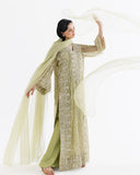 Woman wearing lime green net kaftan with organza dupatta draped and raised overhead