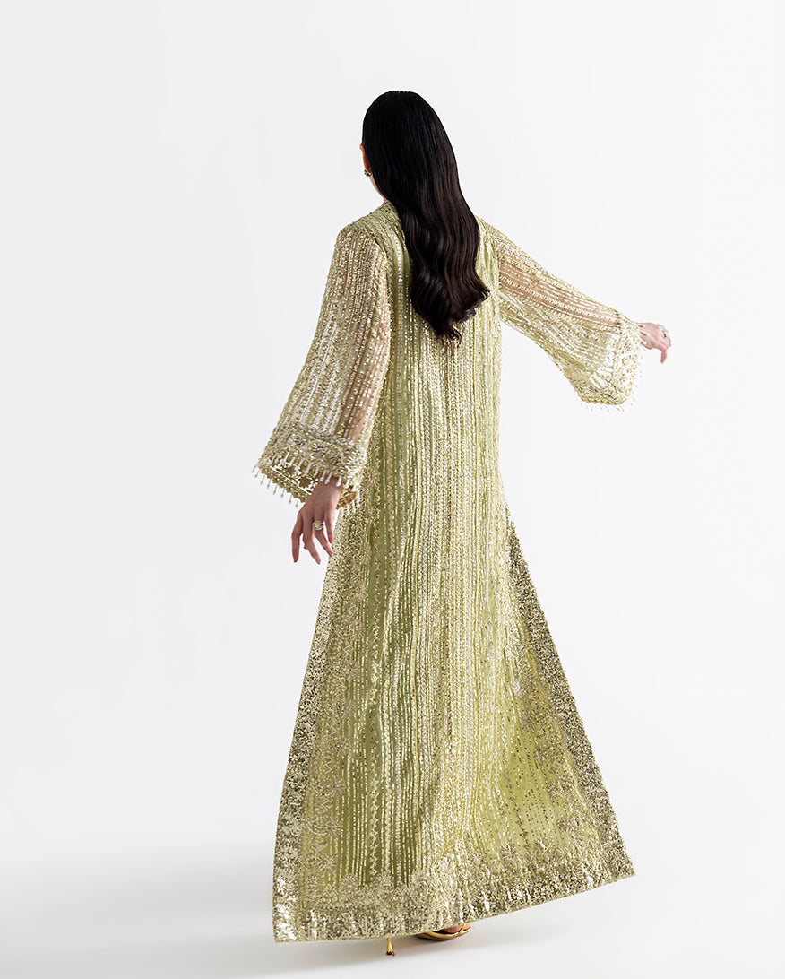 Back view of lime green net kaftan showing fringed bell sleeves and flowing silhouette