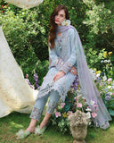 Woman in seated pose wearing sky blue unstitched lawn suit with floral embroidered hem, Secret Garden collectio
