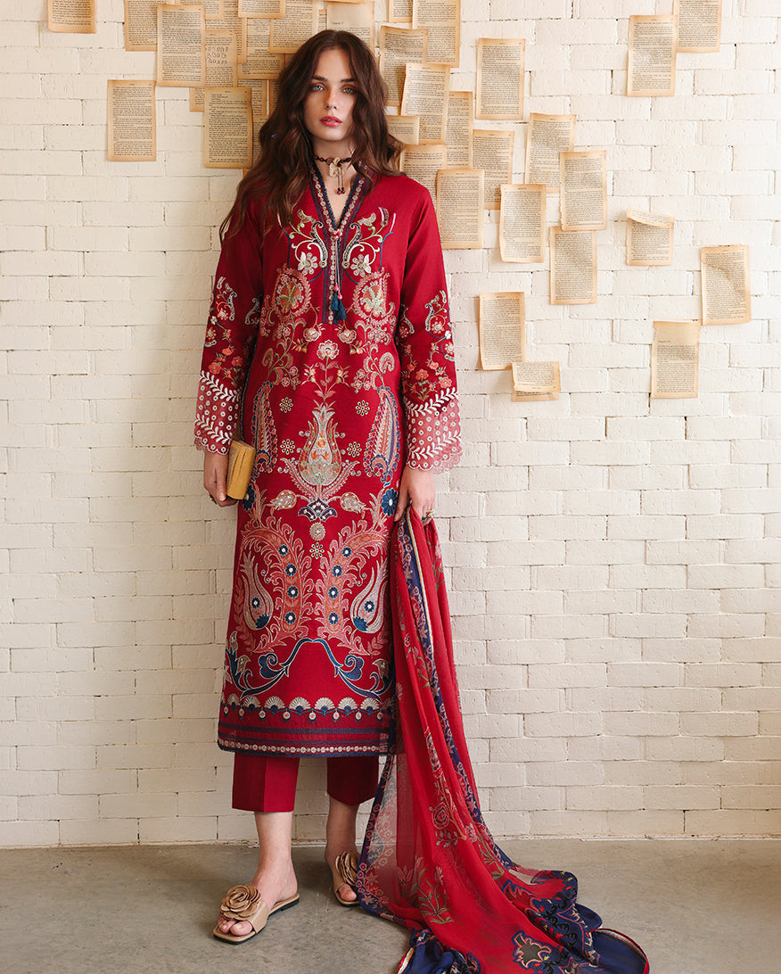 Woman wearing red unstitched lawn suits with paisley embroidery, holding a clutch bag, Secret Garden collection