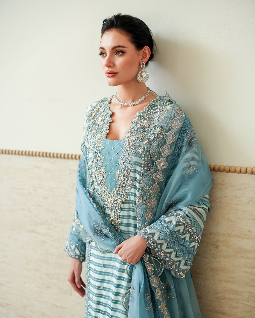 Close-up of embellished V-neckline on Blue brosha suit